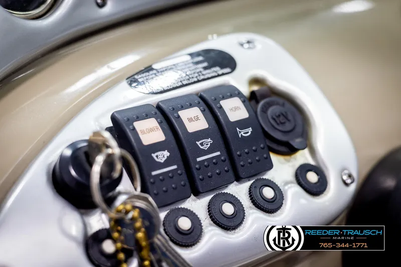 Slide: The Image of Close-up of 2006 Crownline 230 LS boat control panel with switches and key. - 27