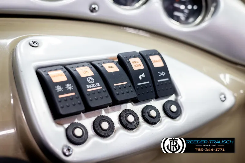 Slide: The Image of Control panel of 2006 Crownline 230 LS boat with labeled switches and dials. - 33