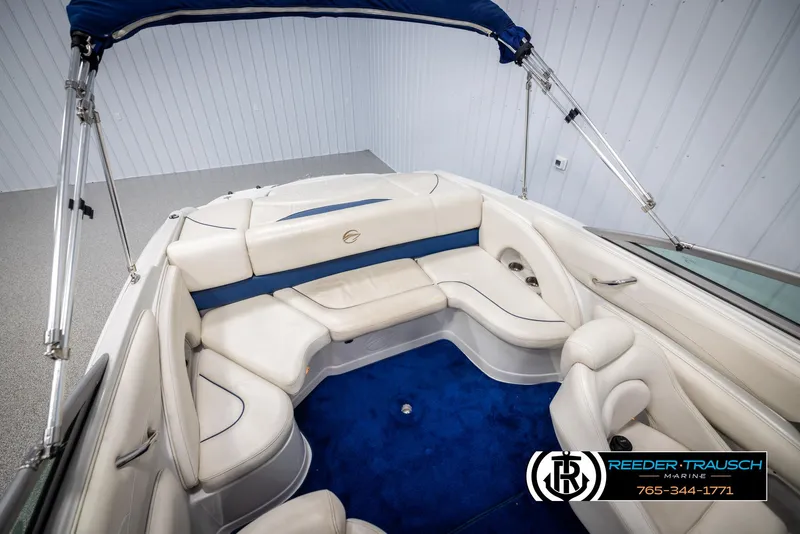 Slide: The Image of 2006 Crownline 230 LS boat interior with white seating and blue carpet. - 43