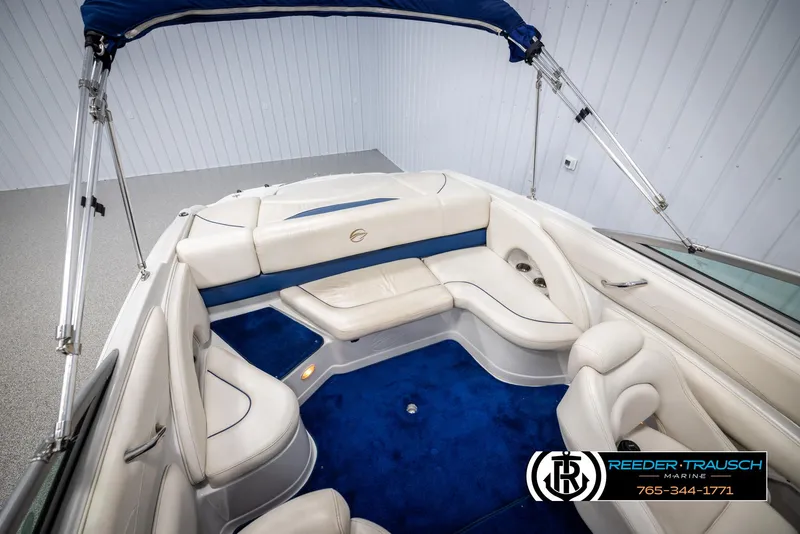 Slide: The Image of 2006 Crownline 230 LS boat interior with blue and white seating and canopy. - 44