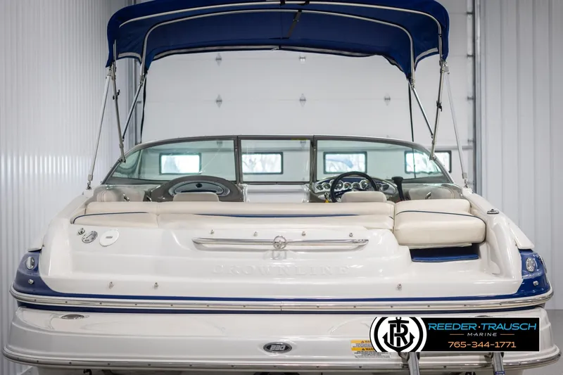 Slide: The Image of 2006 Crownline 230 LS boat with blue canopy in indoor storage. - 7