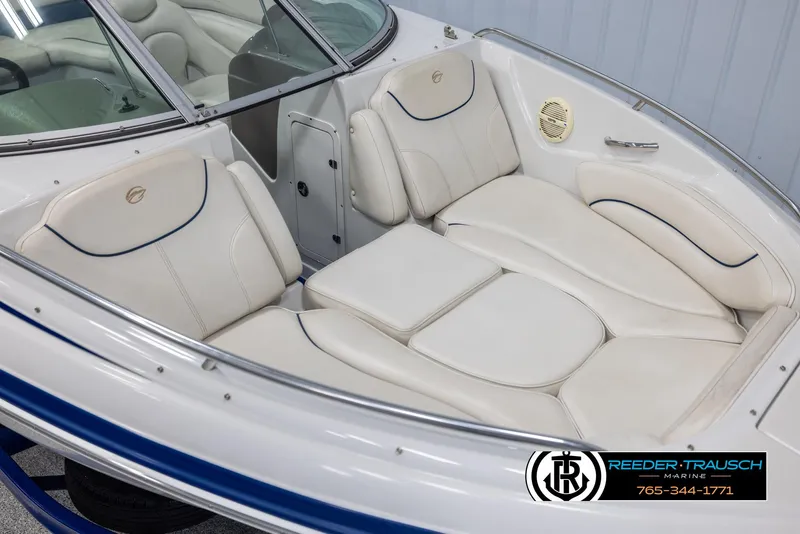 Slide: The Image of 2006 Crownline 230 LS boat interior with white leather seating and blue accents. - 9