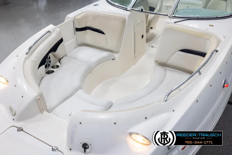 Slide: The Image of 2002 Chaparral 243 Sunesta boat interior with white seating and cup holders. - 10