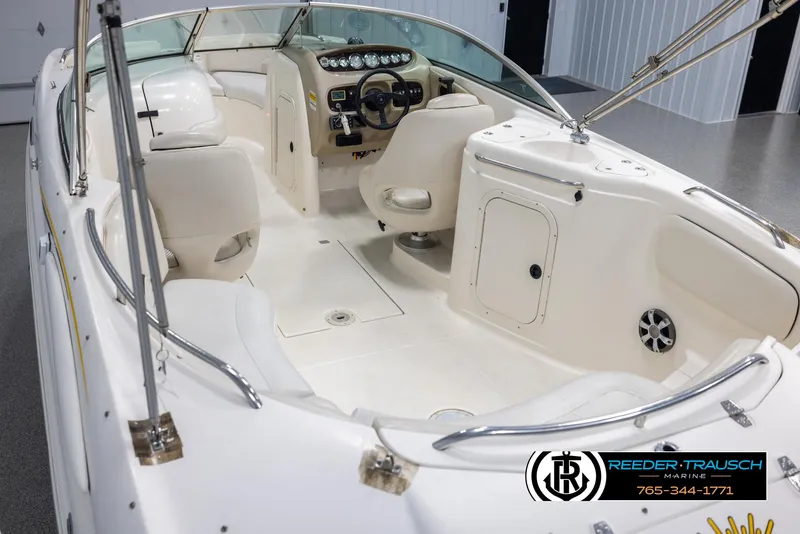 Slide: The Image of 2002 Chaparral 243 Sunesta boat interior with white seating and control panel. - 11