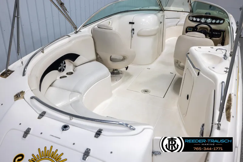 Slide: The Image of 2002 Chaparral 243 Sunesta boat interior with white seating and dashboard. - 12