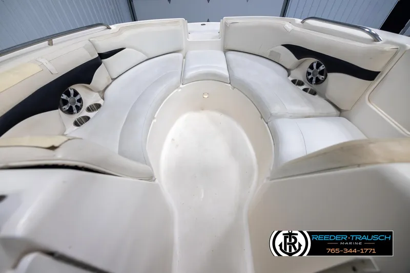 Slide: The Image of Interior view of 2002 Chaparral 243 Sunesta boat with white seating and cup holders. - 15