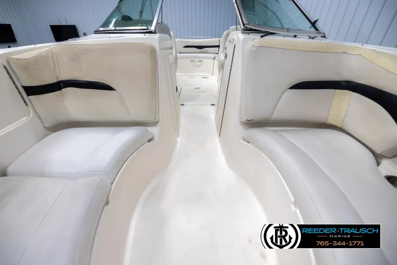 Slide: The Image of Interior view of 2002 Chaparral 243 Sunesta boat with white seating and windshield. - 16