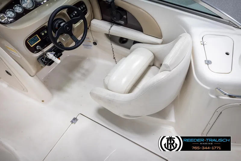 Slide: The Image of 2002 Chaparral 243 Sunesta boat interior with steering wheel and dashboard controls. - 22
