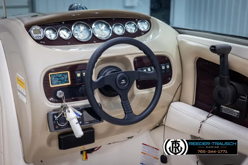Slide: The Image of Dashboard of a 2002 Chaparral 243 Sunesta boat with steering wheel and controls. - 24