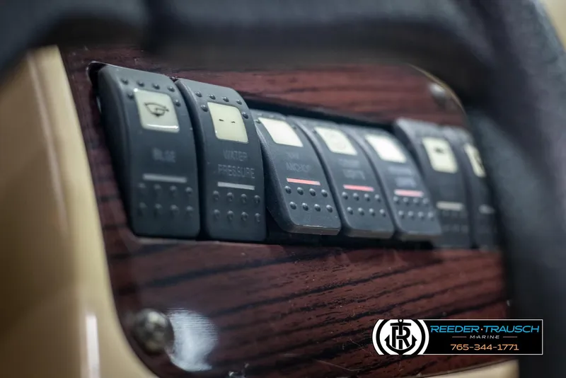 Slide: The Image of Control panel of a 2002 Chaparral 243 Sunesta boat with labeled switches. - 34