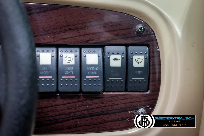 Slide: The Image of Control panel of a 2002 Chaparral 243 Sunesta boat with various switches. - 35