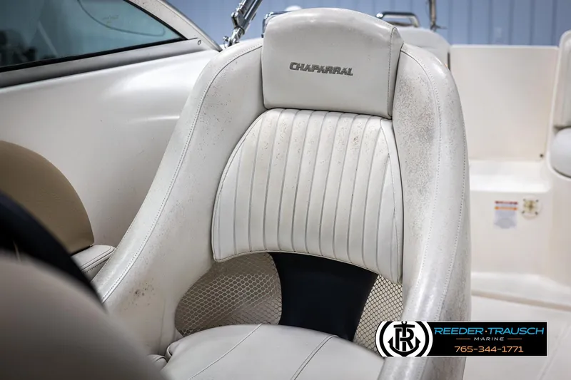 Slide: The Image of White leather seat in 2002 Chaparral 243 Sunesta boat, featuring logo and stitching details. - 36