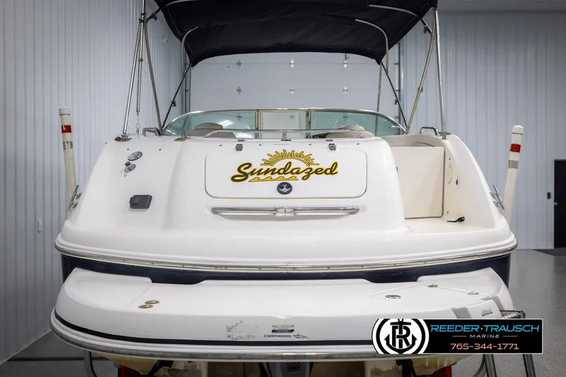 Slide: The Image of 2002 Chaparral 243 Sunesta boat, rear view, indoors, with "Sundazed" text on the back. - 7