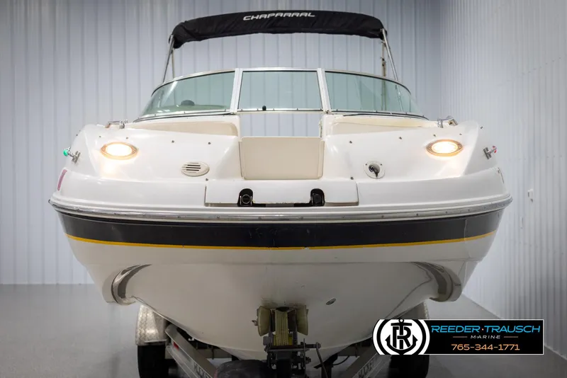 Slide: The Image of 2002 Chaparral 243 Sunesta boat in showroom, front view with lights on. - 8