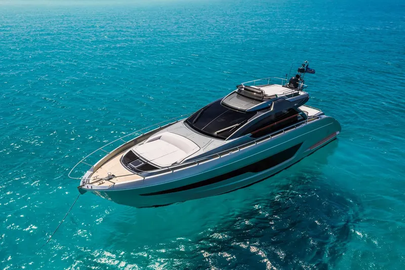 Slide: The Image of 2024 Riva 66' Ribelle yacht cruising on clear blue ocean waters. - 10