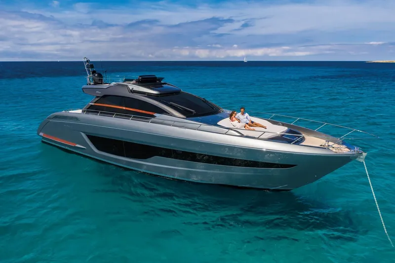 Slide: The Image of 2024 Riva 66' Ribelle yacht cruising on clear blue waters. - 11