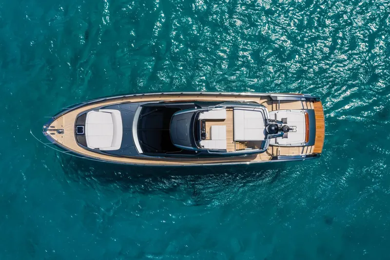 Slide: The Image of Aerial view of 2024 Riva 66' Ribelle yacht on turquoise water. - 12