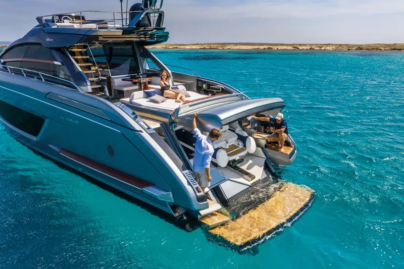 Slide: The Image of Luxury 2024 Riva 66' Ribelle yacht on turquoise waters, featuring sunbathing deck and swim platform. - 13