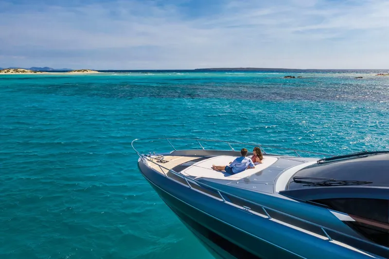 Slide: The Image of 2024 Riva 66' Ribelle yacht cruising on clear blue waters. - 16