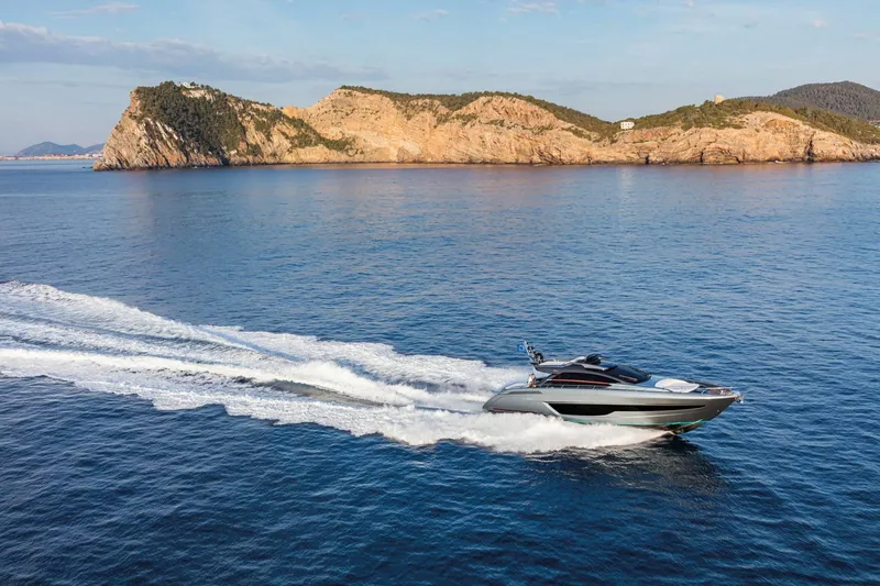 Slide: The Image of 2024 Riva 66' Ribelle yacht cruising near rocky coastline. - 4