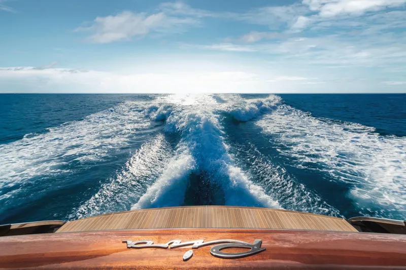 Slide: The Image of Riva 66' Ribelle 2024 yacht cruising on open sea, leaving a wake trail. - 5