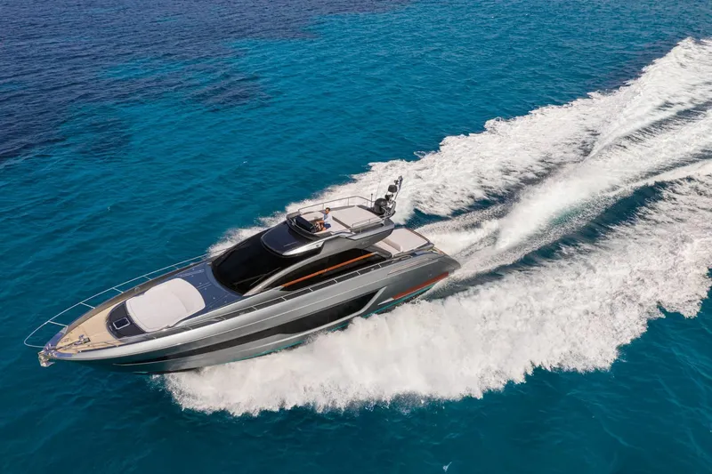 Slide: The Image of 2024 Riva 66' Ribelle luxury yacht cruising on clear blue waters. - 9