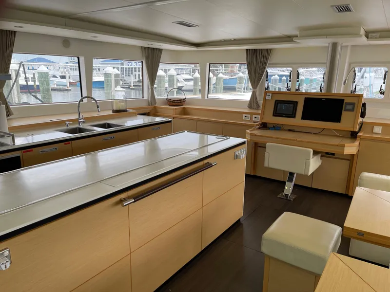 Slide: The Image of Interior of a 2014 Lagoon 620 yacht with modern kitchen and helm station. - 14