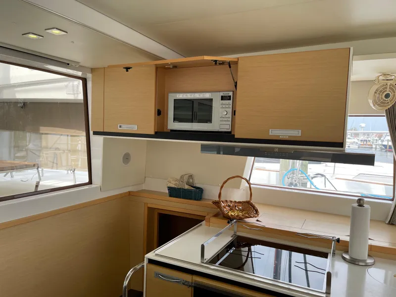 Slide: The Image of Interior of Lagoon 620 yacht kitchen with microwave, 2014 model. - 17