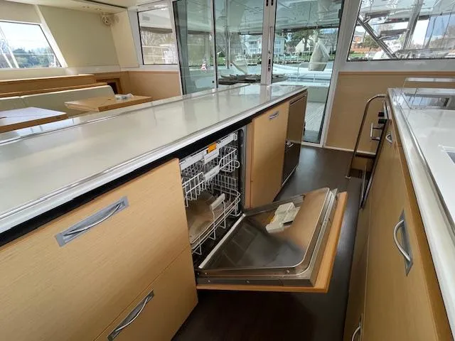 Slide: The Image of Interior of a 2014 Lagoon 620 yacht with open dishwasher. - 18