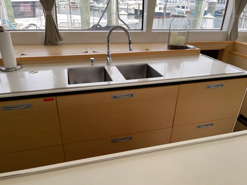 Slide: The Image of Interior of Lagoon 620 yacht kitchen, 2014 model, featuring double sink. - 23