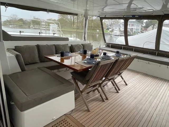 Slide: The Image of Interior of Lagoon 620 yacht, dining area with set table. - 47