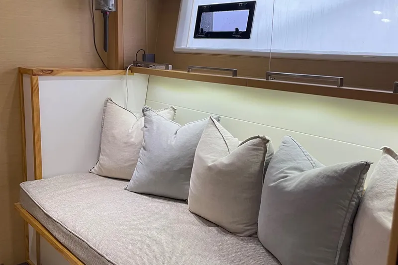 Slide: The Image of Lagoon 620 yacht interior, cozy seating area with cushions, 2014 model. - 5