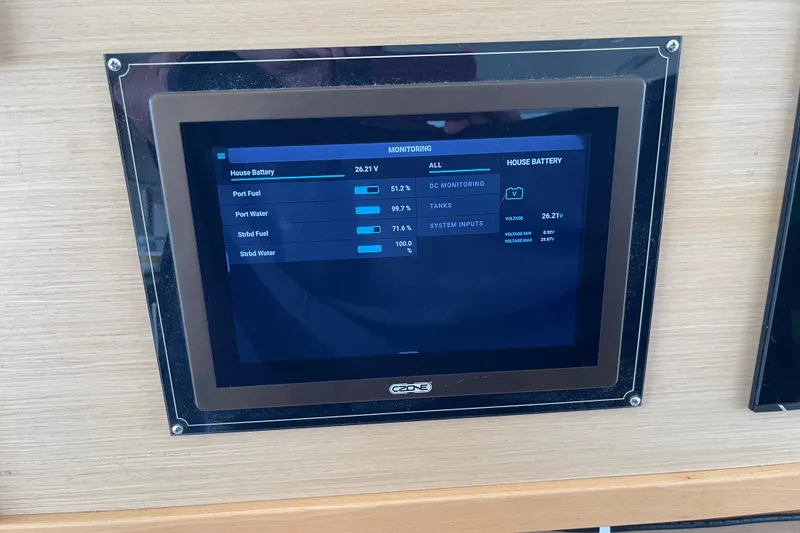 Slide: The Image of Control panel display on a 2014 Lagoon 620 yacht, showing battery and tank levels. - 52