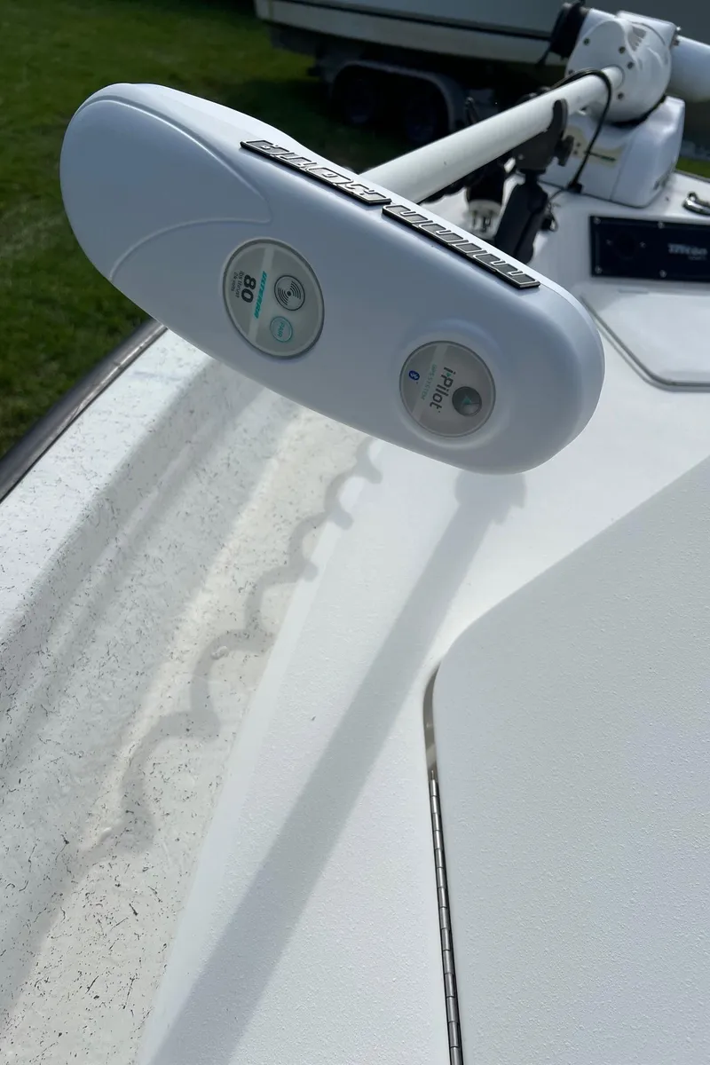 Slide: The Image of Triton 23 Tunnel 2000 boat with mounted trolling motor on deck. - 10