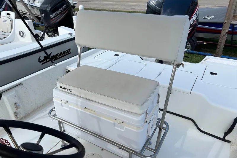 Slide: The Image of Triton 23 Tunnel 2000 boat with cushioned seating and Igloo cooler on deck. - 12