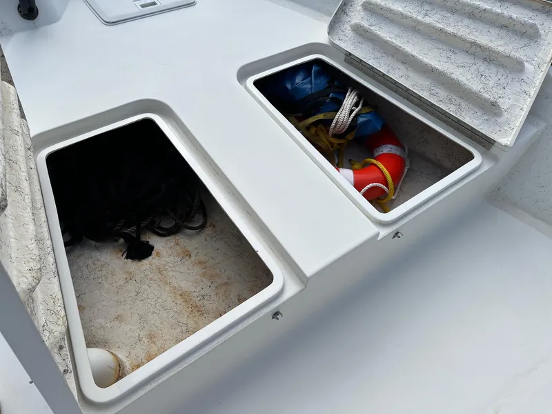 Slide: The Image of Open storage compartments on a 2000 Triton 23 Tunnel boat deck. - 3