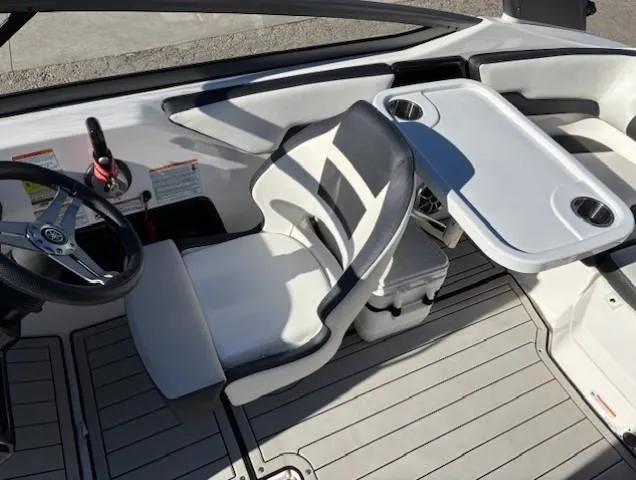Slide: The Image of 2020 Yamaha Boats 195S interior with steering wheel, seating, and table. - 15