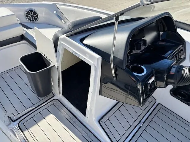 Slide: The Image of 2020 Yamaha Boats 195S interior with sleek dashboard and storage compartment. - 19
