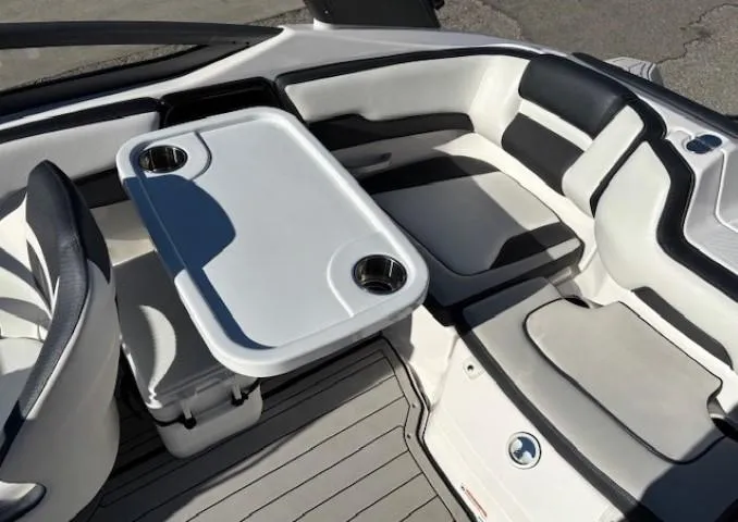 Slide: The Image of 2020 Yamaha Boats 195S interior with seating and table, featuring cup holders. - 22
