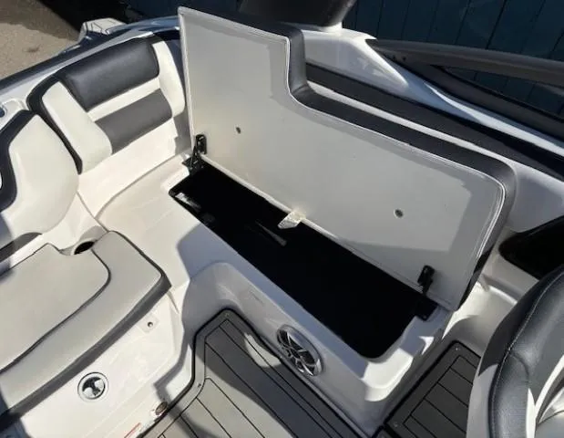 Slide: The Image of 2020 Yamaha Boats 195S interior storage compartment with seating and speaker. - 25