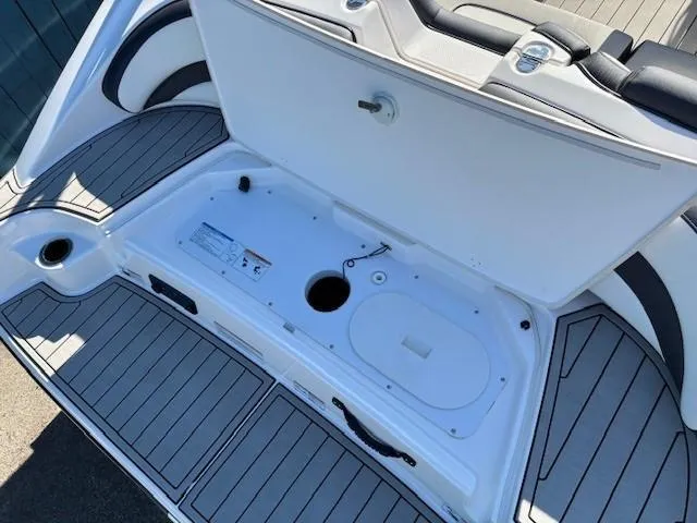 Slide: The Image of 2020 Yamaha Boats 195S storage compartment with open hatch and sleek design. - 31