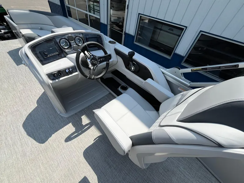Slide: The Image of 2025 Avalon LSZ Versatile Rear Bench boat interior with steering wheel and dashboard controls. - 22