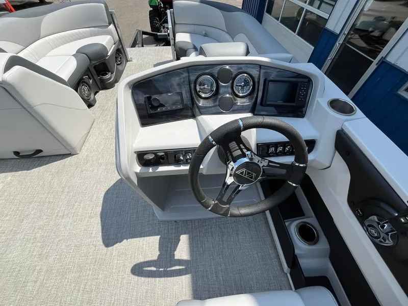 Slide: The Image of 2025 Avalon LSZ Versatile Rear Bench boat interior with modern steering console and seating. - 23