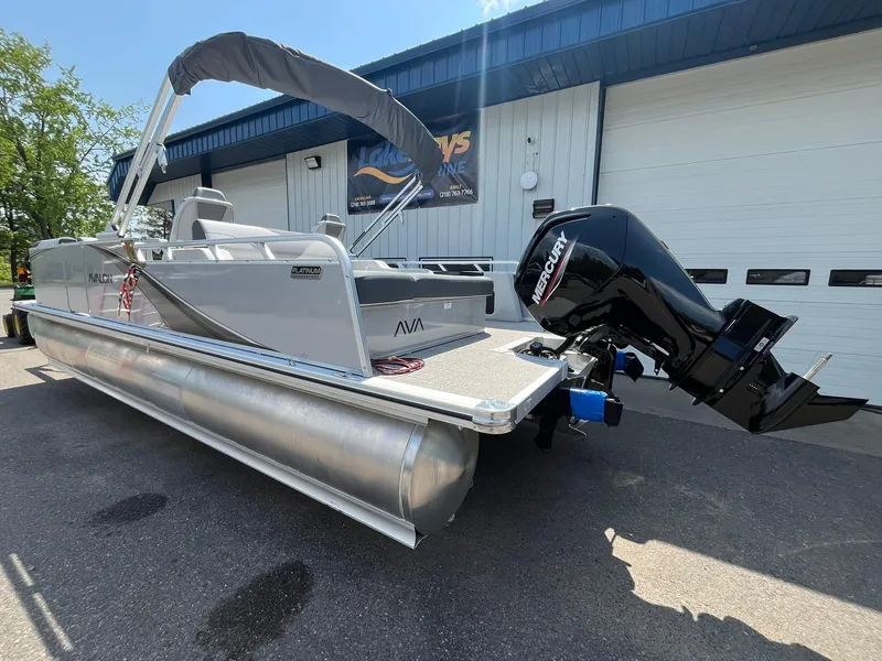 Slide: The Image of 2025 Avalon LSZ Versatile Rear Bench pontoon boat with Mercury outboard motor. - 6