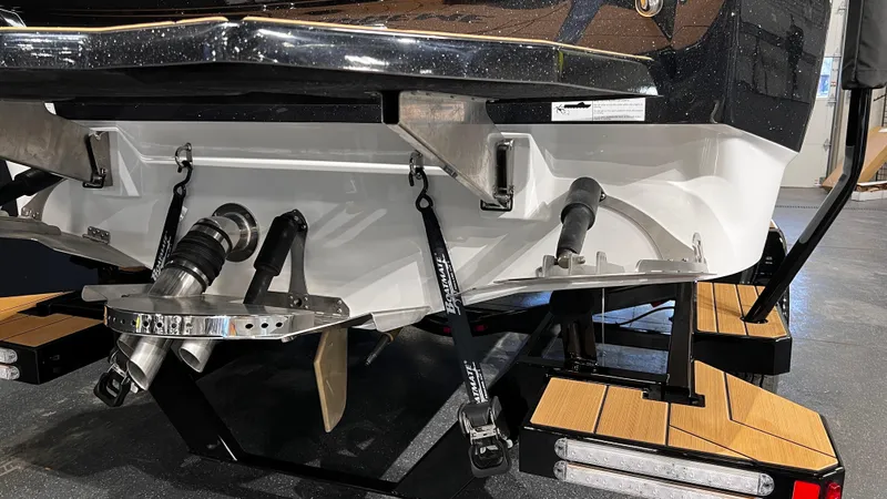 Slide: The Image of 2024 Supreme S220 boat stern with propeller and trailer. - 11