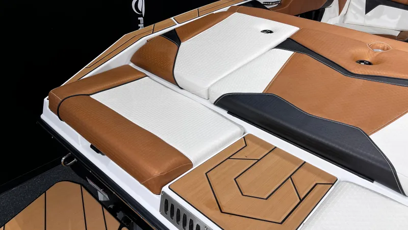Slide: The Image of 2024 Supreme S220 boat interior with brown and white cushioned seating. - 13