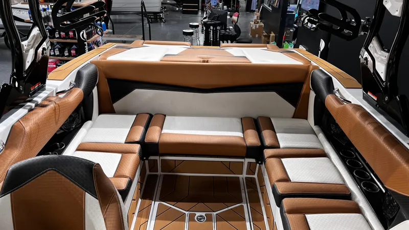 Slide: The Image of 2024 Supreme S220 boat interior with luxurious brown and white seating. - 16