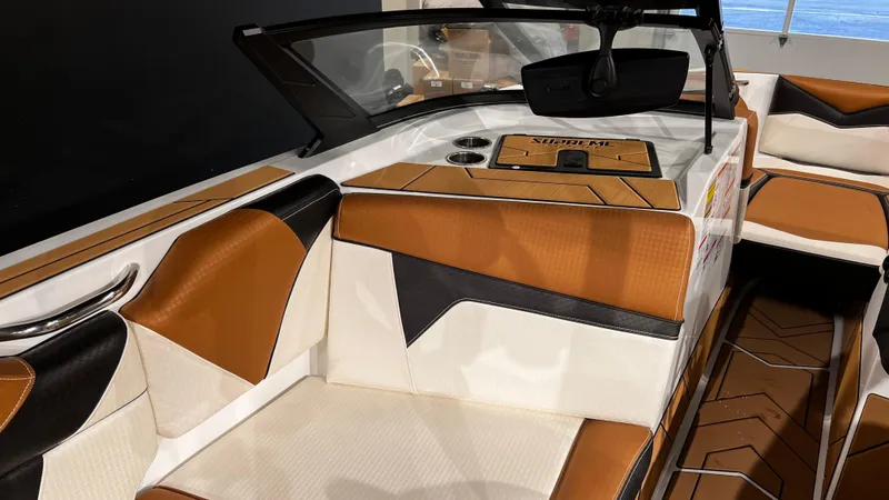 Slide: The Image of 2024 Supreme S220 boat interior with brown and white leather seating. - 21