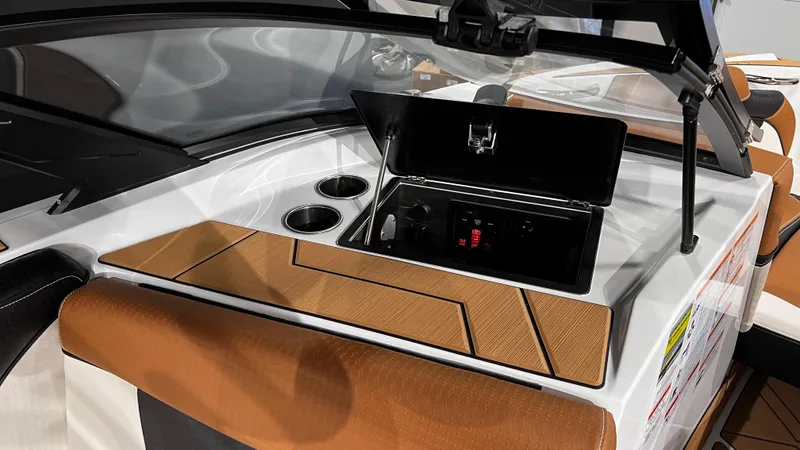 Slide: The Image of 2024 Supreme S220 boat interior with storage compartment and cup holders. - 22