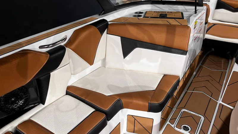 Slide: The Image of 2024 Supreme S220 boat interior with brown and white seating. - 24